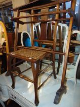 A wooden early towel rail and rattan seated chair