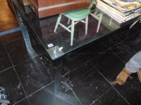 A glass contemporary dining table