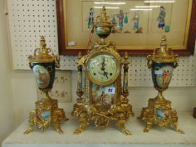 A gilt clock garniture set