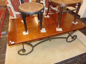 A Mahogany and wrought iron coffee table