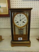 A brass and glass mantle clock