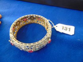 A White metal bangle, set with Rubies and Diamonds, approx.