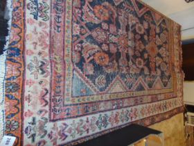 A brown ground Persian rug