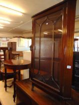 A glazed corner cabinet