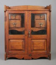 An oak smokers cabinet, with twin beveled glass panels and interior drawers. Height: 55cm, Width: