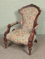 A Victorian carved mahogany armchair with tapestry upholstery. Signs of damage/repair to frame,