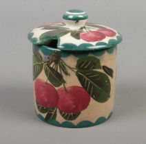 A Weymss ware preserve pot and cover, decorated in cherries. Bearing marks 'T. Goode and Co' to