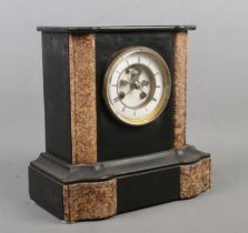 A black slate and marble mantel clock. Having Roman numeral markers. The movement stamped for