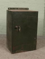 A vintage green painted steel locking cabinet.