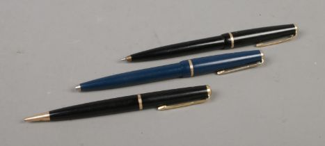 Three ballpoint Parker pens, two of three working.