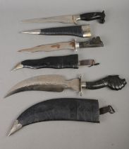 Three Indian knives to include Kukri example, each featuring carved ebonized handles in the form