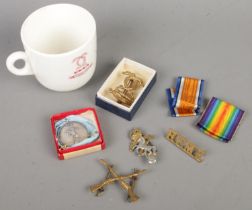 A small quantity of military collectables. Includes St Lawrence College cap badge, ribbons, etc.