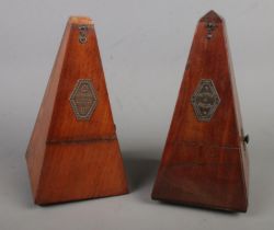 Two mahogany cased metronomes stamped for 'Metronome de Maelzel' and 'Metronome Nach Maelzel'.