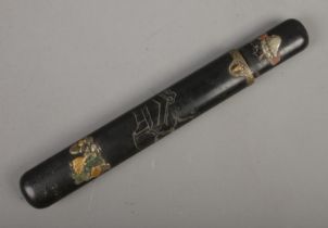 A Japanese black lacquered Kiseru-zutsu (Pipe case) of flatted cylindrical form decorated with