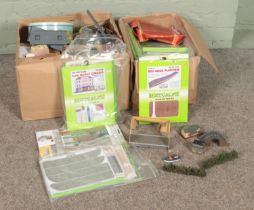 Two boxes of assorted model railway scenery to include buildings, background decor, etc.