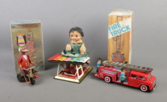 Three vintage tinplate toys to include Xylophone player, boxed Friction Fire Truck and boxed Duck