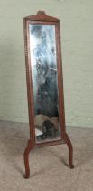An early 20th century carved oak cheval mirror with strut support. Height 140cm.