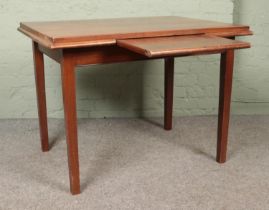 A mahogany table with central slide and square tapering legs