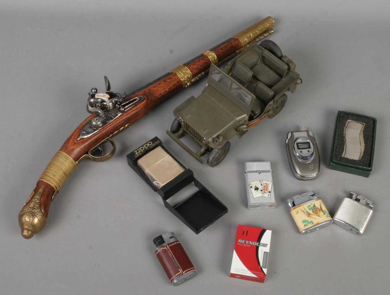 A small quantity of collectables. Mostly lighters. Includes cased Zippo Marlboro example, replica