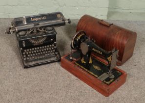 An early 20th century Imperial typewriter along with a cased hand crank Singer sewing machine. No