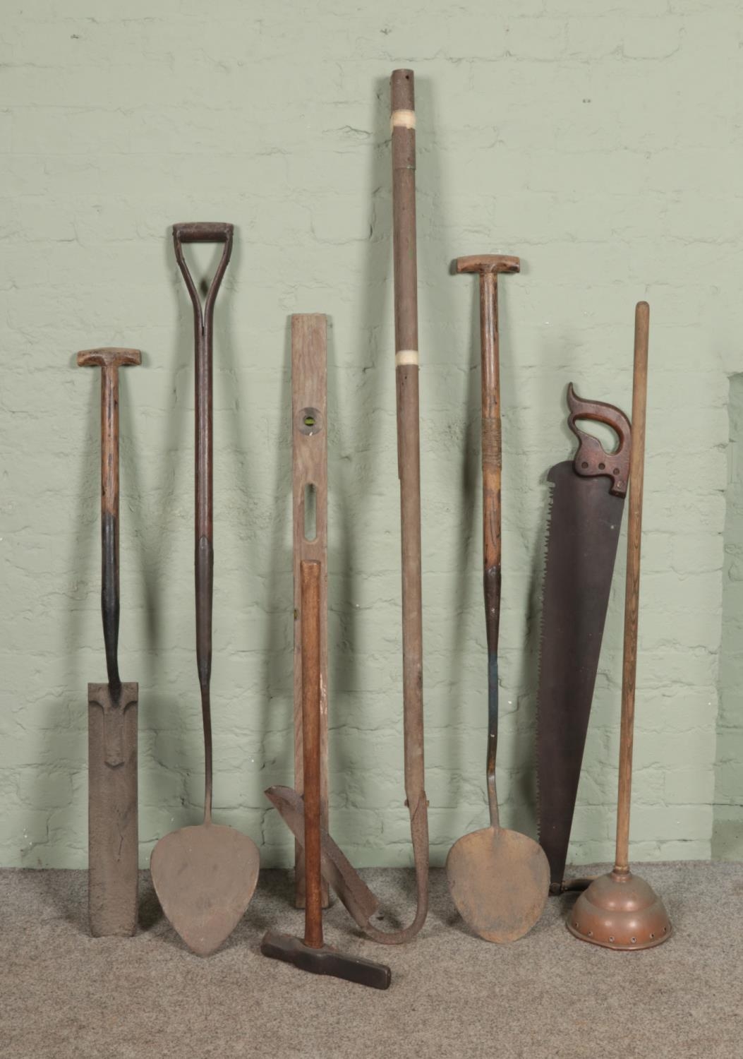 A collection of vintage tools including drain spade/trenching spade, spirit level, spike maul etc