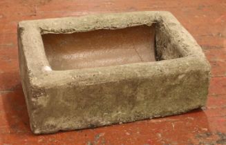 A concrete garden trough, with slanted and raised back. Height: 22cm, Width: 59cm, Depth: 38cm.