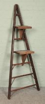 A set of wooden ladders, set with two steps. Possibly used for fruit picking. 178cm tall.