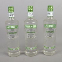 Three sealed 70cl bottles of Smirnoff Green Apple vodka.