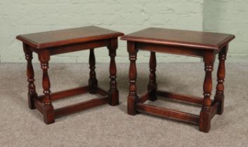A pair of small oak occasional tables with turned supports.