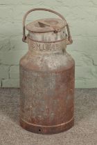 A aluminium milk churn with SML 49 embossed to neck. Hx56cm approx.