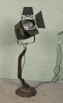 A vintage Strand Electric spotlight on metal stand. Not in working order.