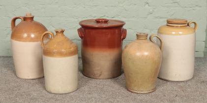 A collection of stoneware, to include four flagons and twin handled bread bin. Including advertising