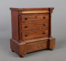 A miniature mahogany chest of drawers in the Victorian style. 27cm x 25cm x 14cm.