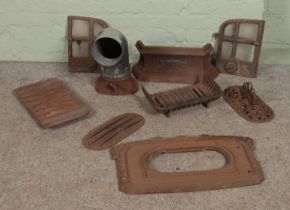 A collection of cast iron fire grate spares to include decorative floral examples.