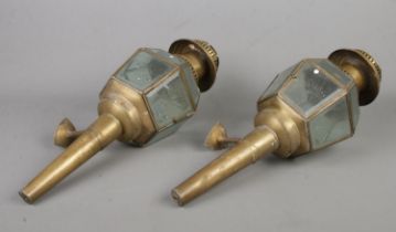 A pair of early Twentieth century brass coach lights, fitted with frosted bevel glass panels. Bear