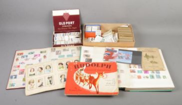 An assortment of collectables to include Brooke Bond Cigarette Cards, two partially filled world