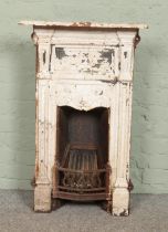 A Victorian painted cast iron bedroom fireplace. 91cm x 58cm.