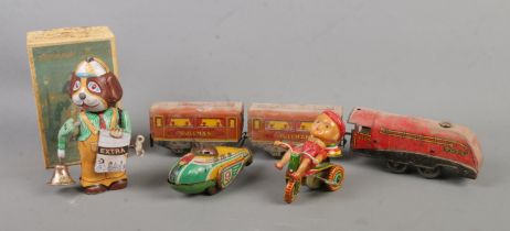 Four vintage tinplate wind up toys to include The National 2509 locomotive with two carriages, boxed