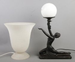 Two table lamps, to include figural example holding sphere. Figural example has chipped foot, a chip