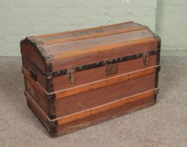 A vintage wood bound travel trunk. Stencilled to the top JNW.