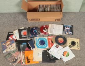 A box of 45 RPM single records. Includes Simply Red, Ghostbusters, Shadows, Bay City Rollers,