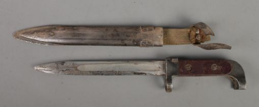 An AK47 bayonet with scabbard. Blade length 19cm. CANNOT POST OVERSEAS