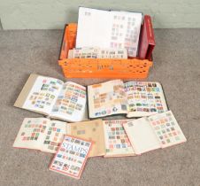 A large collection if stamps from around the world in several albums including the complete guide to