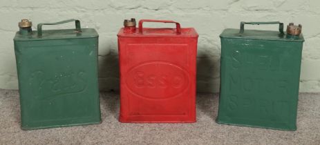 Three vintage petrol cans; Pratts, Shell and Esso.