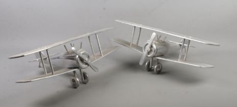 A pair of chrome models of bi planes. Wing span 49cm.