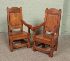 A pair of childs elm arm chairs with panelled backs and turned supports. Height of back 73.5cm.