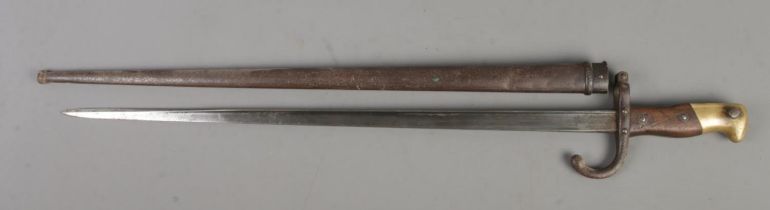 A French 1874 bayonet with scabbard. Inscribed to edge of blade and dated 1878. Blade length 52cm.