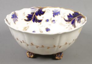 A large Rockingham bowl with blue & gilt floral decoration. Baring puce mark to the base. (