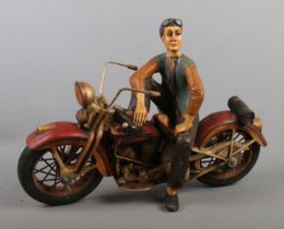 A large composite figure of a man on Harley Davidson motorbike.