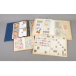 A collection of partially filled world stamp albums to include Marilyn Monroe first day covers,
